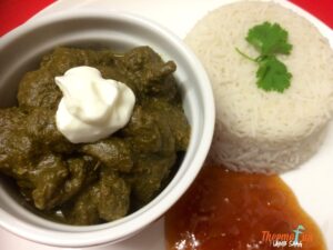 Lamb saag with yoghurt and rice on a dish