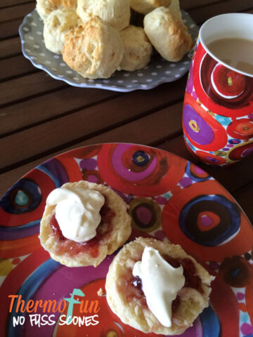 Thermomix made scones with jam and cream on a plate