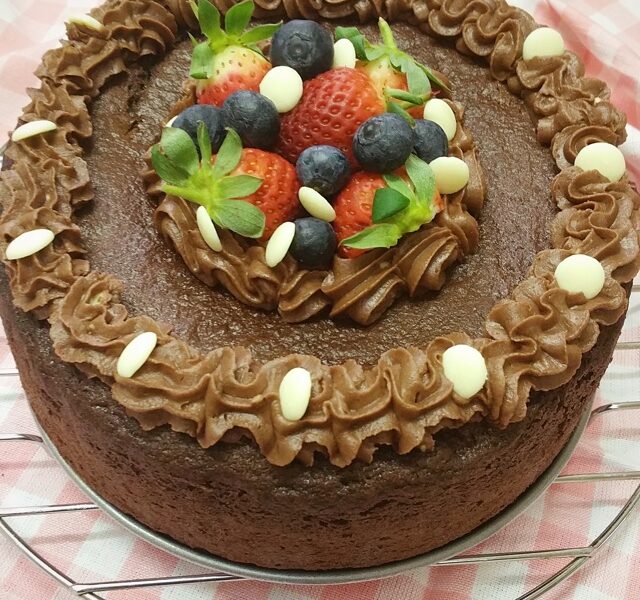 Chocolate cake decorated with icing and fruit