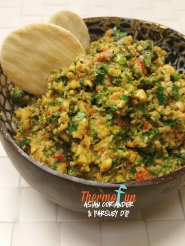 Thermomix Asian coriander and parsley dip in a bowl with crackers