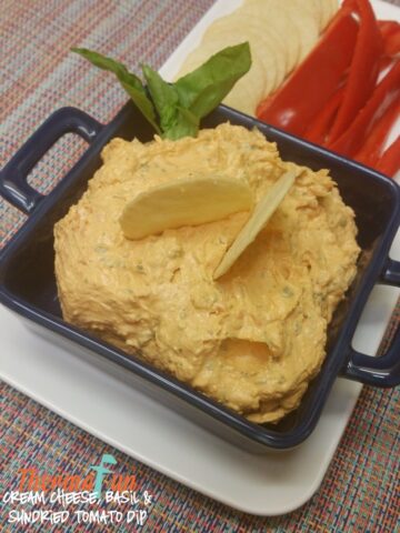 Thermomix Basil and Sun-Dried Tomato Dip in a dish with crackers
