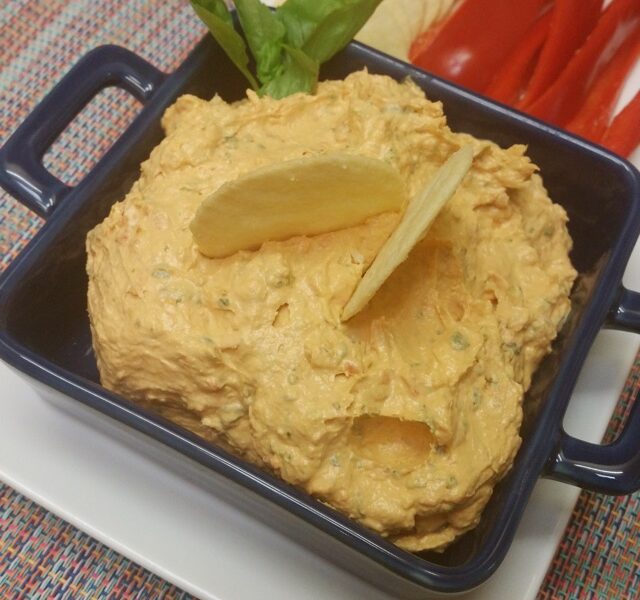 Thermomix Basil and Sun-Dried Tomato Dip in a dish with crackers